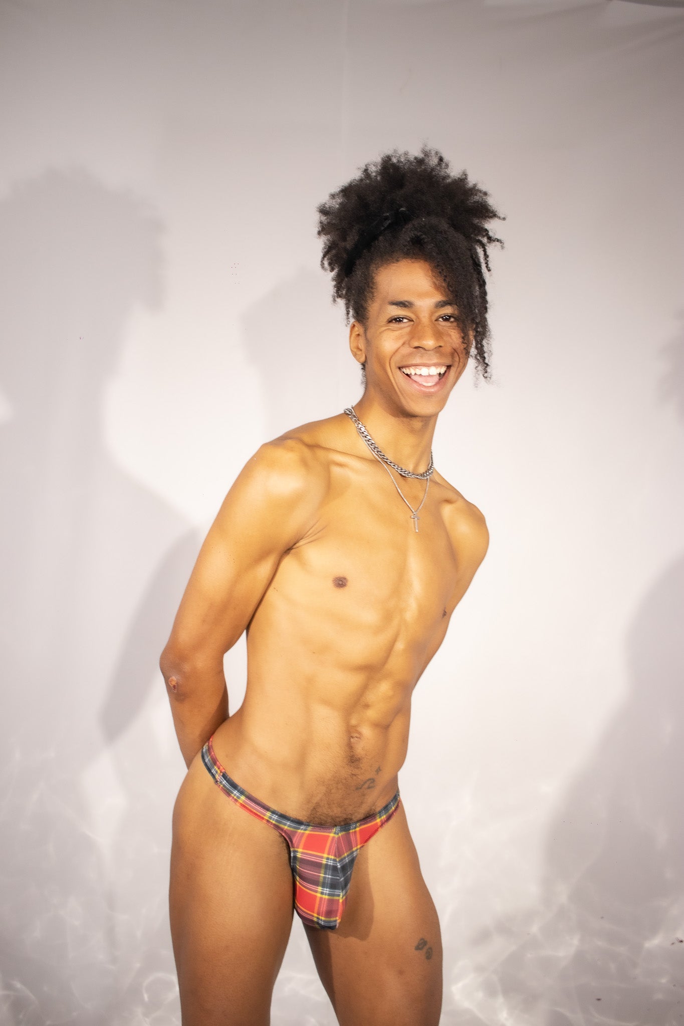 Person wearing a plaid thong against a plain background