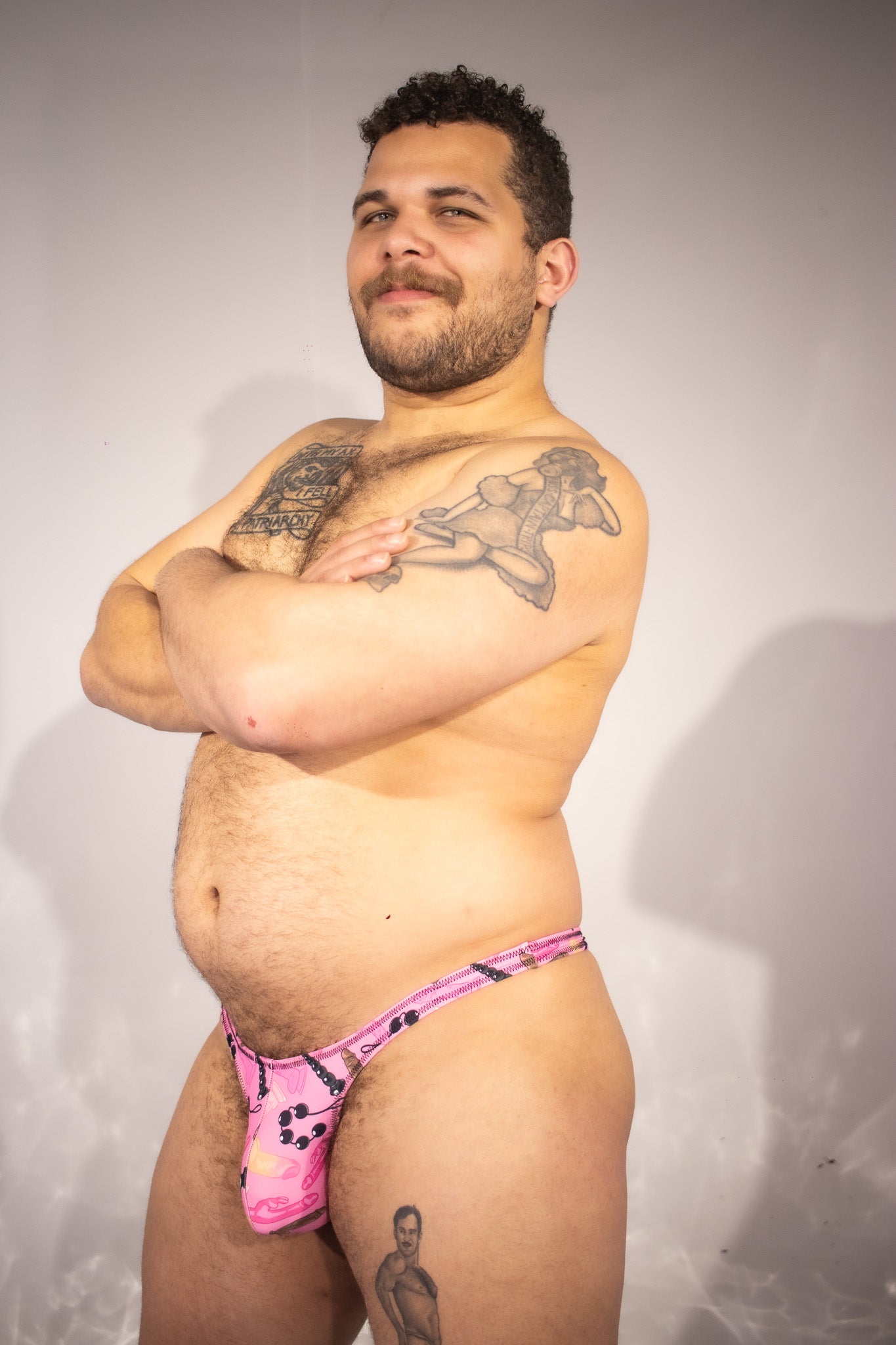 Man wearing pink thong with a white background